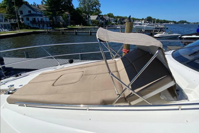  Yacht Photos Pics 2012 Prestige 500 yacht with sunbed and canopy, docked by a scenic waterfront.