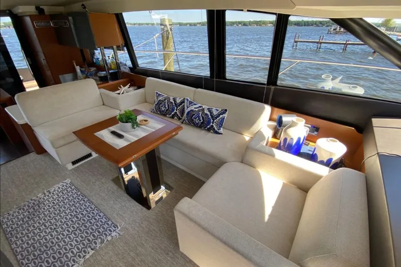  Yacht Photos Pics Luxurious interior of 2012 Prestige 500 yacht with elegant seating and scenic water view.