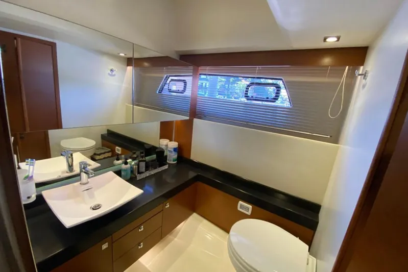  Yacht Photos Pics Luxurious bathroom interior of 2012 Prestige 500 yacht with modern fixtures and window.