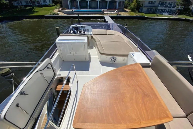  Yacht Photos Pics Flybridge of 2012 Prestige 500 yacht with seating, table, and helm station.