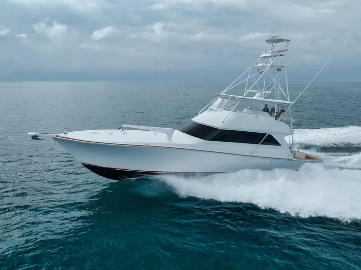  Yacht Photos Pics 2001 Viking 65 yacht cruising on open ocean under cloudy skies.