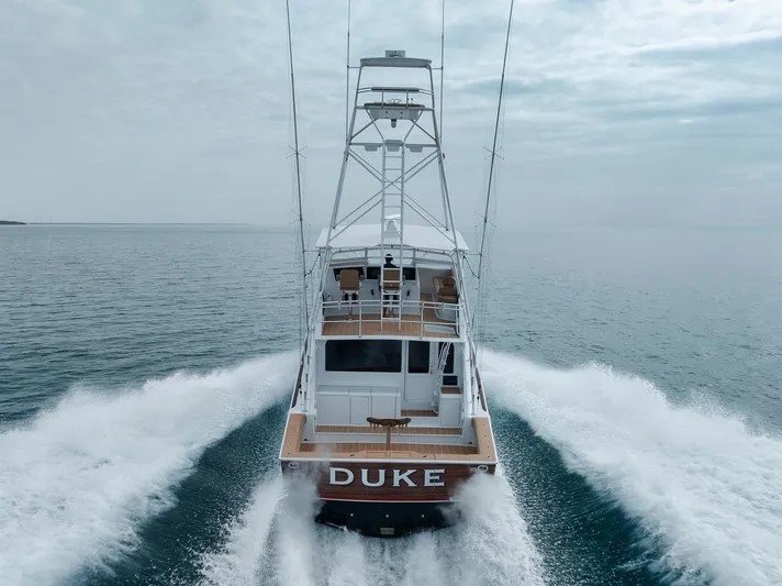  Yacht Photos Pics Viking 65 yacht "DUKE" cruising on open water, rear view, 2001 model.