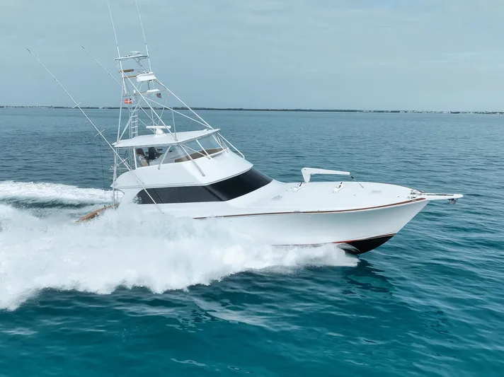  Yacht Photos Pics 2001 Viking 65 yacht cruising on open blue waters.