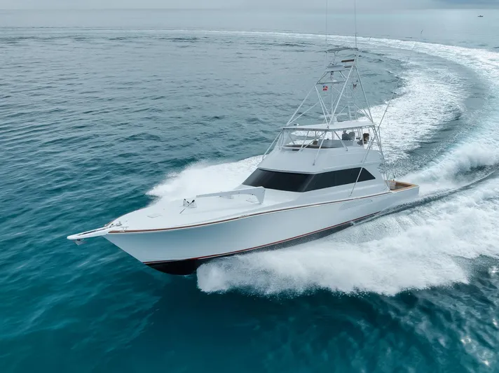  Yacht Photos Pics 2001 Viking 65 yacht cruising swiftly on open ocean waters.