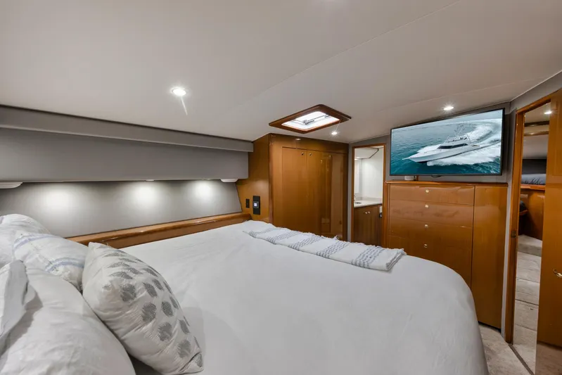  Yacht Photos Pics Luxurious bedroom interior of 2001 Viking 65 yacht with modern amenities and elegant design.