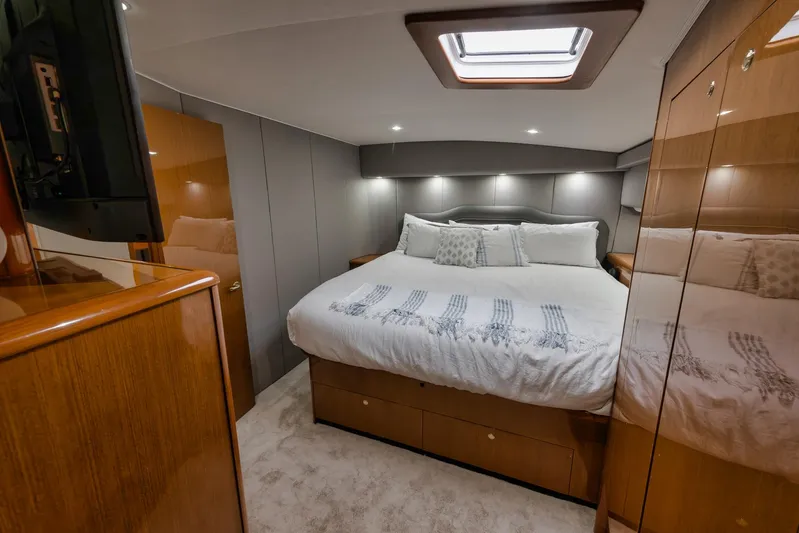  Yacht Photos Pics Luxurious bedroom interior of 2001 Viking 65 yacht with cozy bedding and modern design.