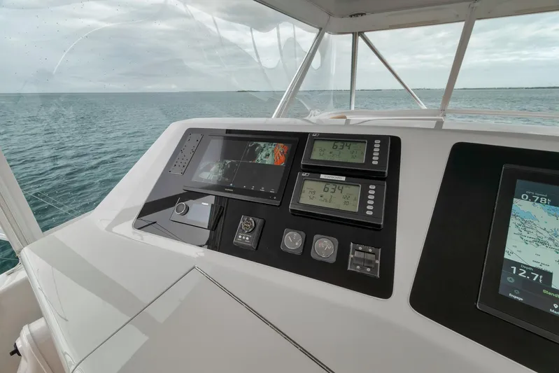 Yacht Photos Pics Control panel of a 2001 Viking 65 yacht with navigation displays and ocean view.