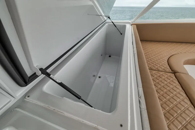  Yacht Photos Pics Open storage compartment on 2001 Viking 65 yacht, with cushioned seating and ocean view.