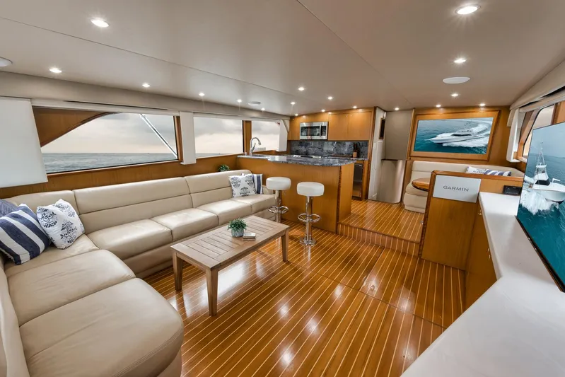  Yacht Photos Pics Luxurious interior of 2001 Viking 65 yacht with modern furnishings and wooden flooring.