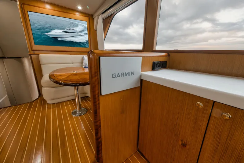  Yacht Photos Pics Luxurious interior of 2001 Viking 65 yacht with wood finish and Garmin equipment.