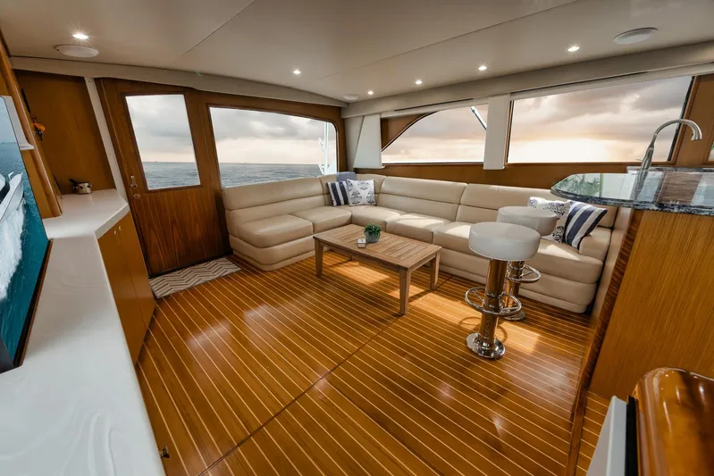  Yacht Photos Pics Luxurious interior of a 2001 Viking 65 yacht with elegant wood flooring and plush seating.