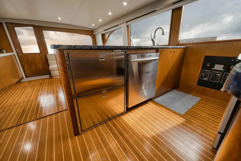  Yacht Photos Pics Luxurious 2001 Viking 65 yacht interior with modern kitchen and wooden flooring.