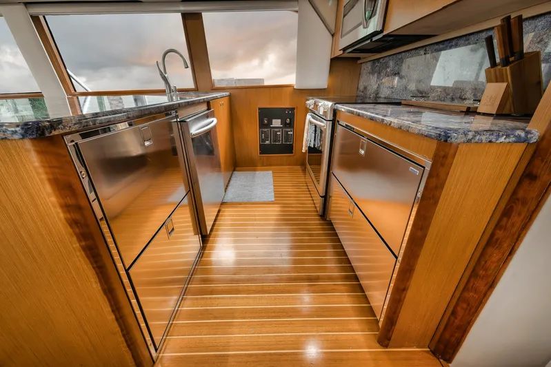  Yacht Photos Pics Luxurious kitchen interior of 2001 Viking 65 yacht with wooden flooring and modern appliances.