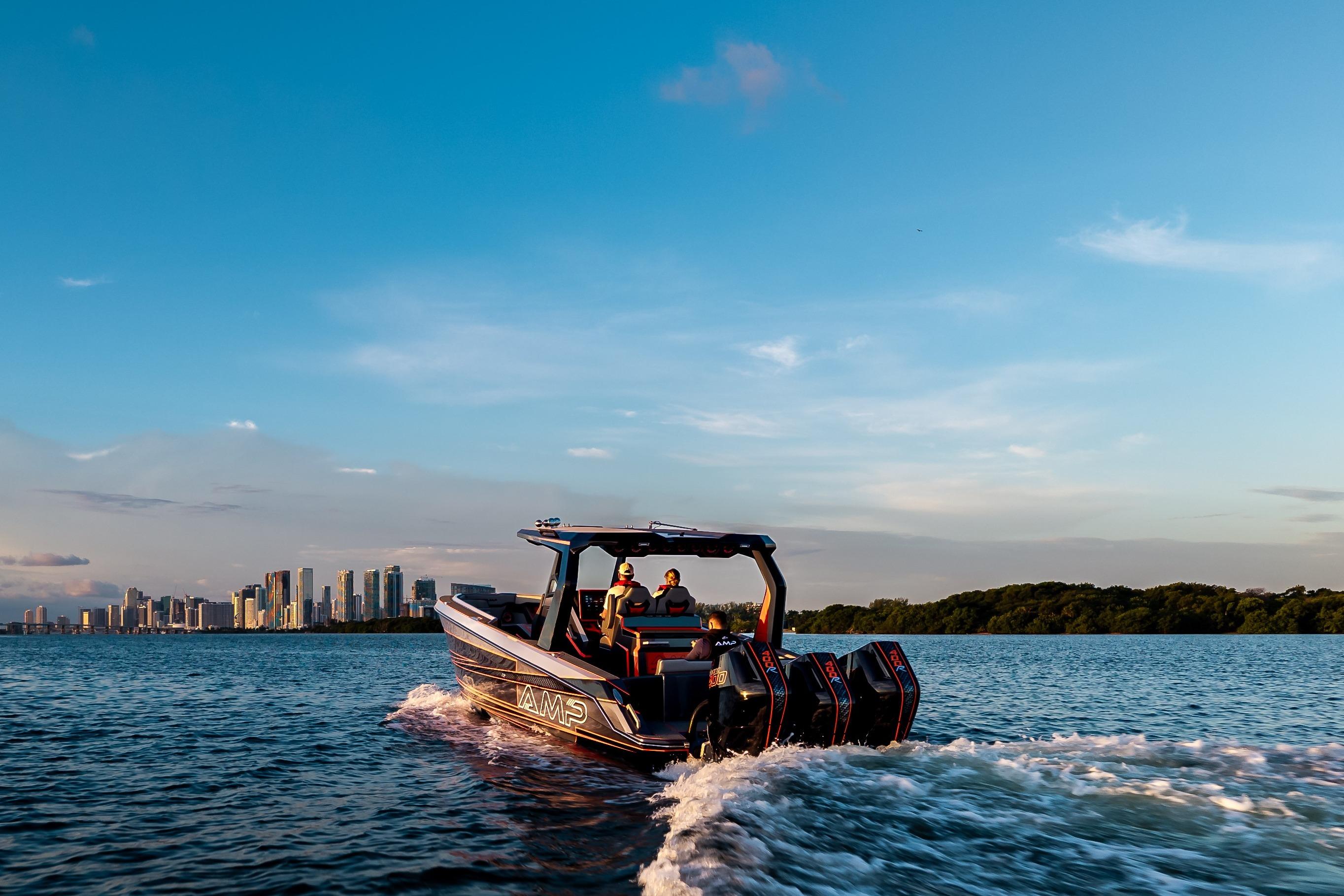Modern AMP 333 boat cruising near city skyline, 2026 model, under clear blue sky.