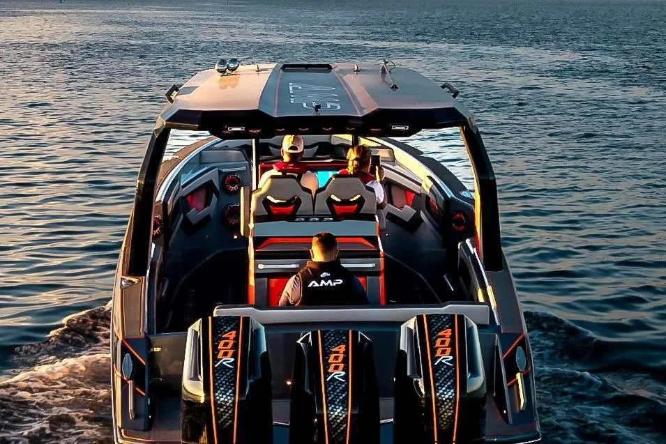 Futuristic AMP 333 boat cruising on water, 2026 model, with passengers enjoying the ride.