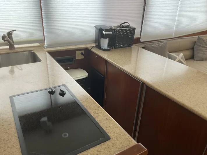  Yacht Photos Pics 1984 Hatteras 52 Convertible yacht kitchen with modern appliances and sleek countertops.