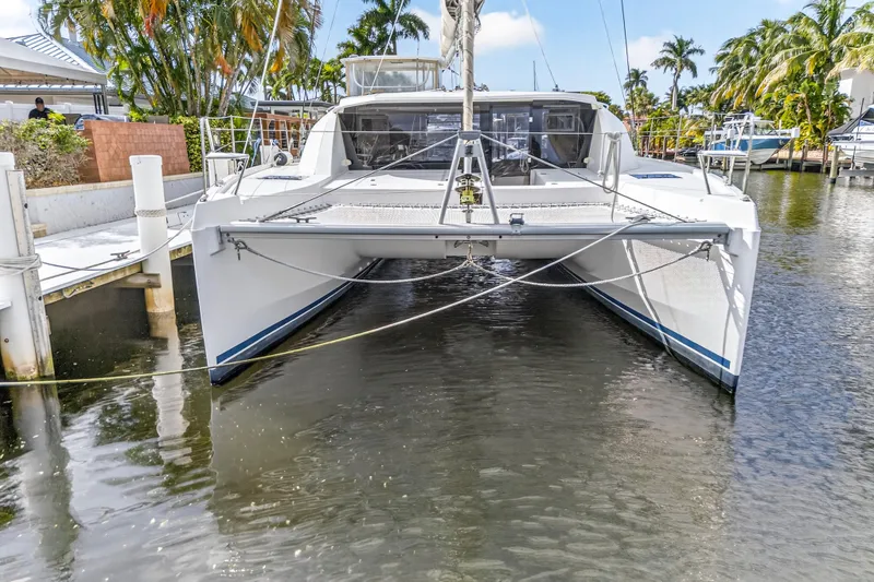  Yacht Photos Pics 2017 Leopard 40 catamaran docked in a sunny marina with palm trees.