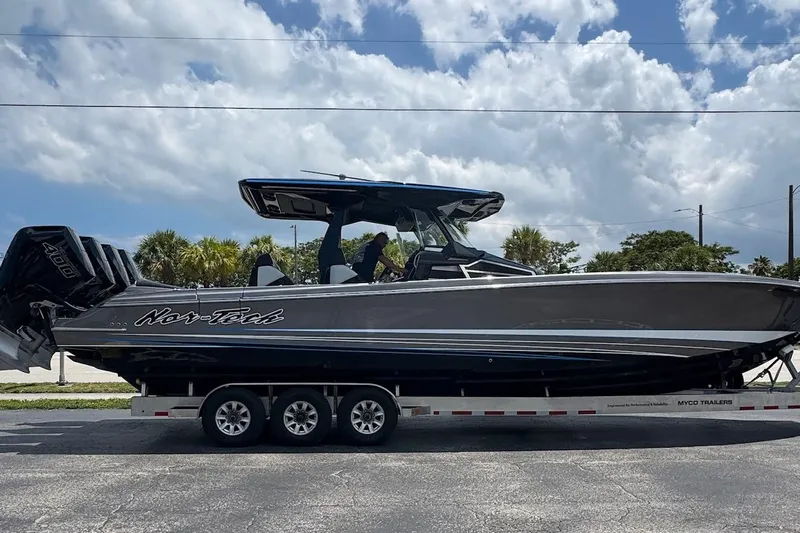  Yacht Photos Pics 2025 Nor-Tech 400 Supersport boat on trailer under cloudy sky.