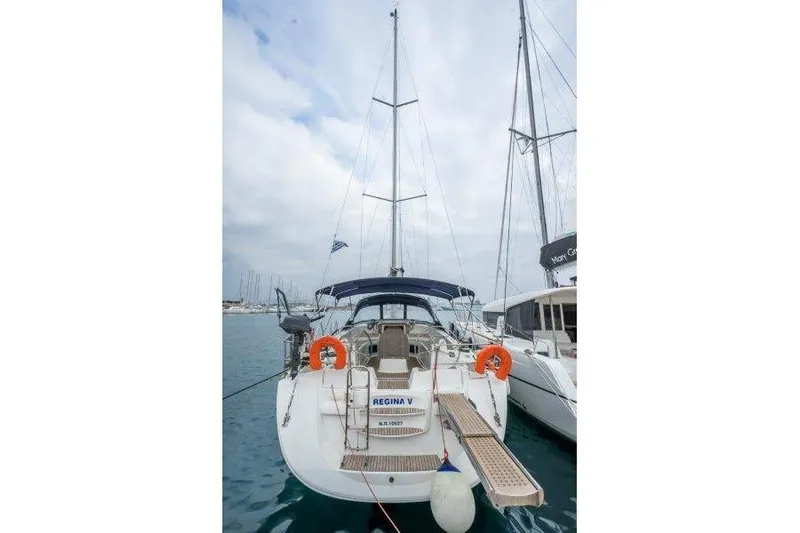  Yacht Photos Pics Jeanneau 53 sailboat, 2010 model, docked with lifebuoys and blue canopy.