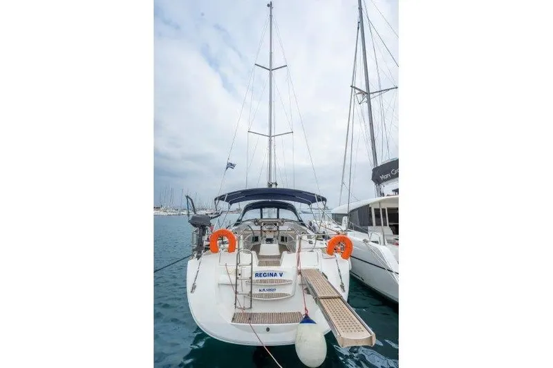  Yacht Photos Pics 2010 Jeanneau 53 sailboat docked, rear view with lifebuoys and gangway.