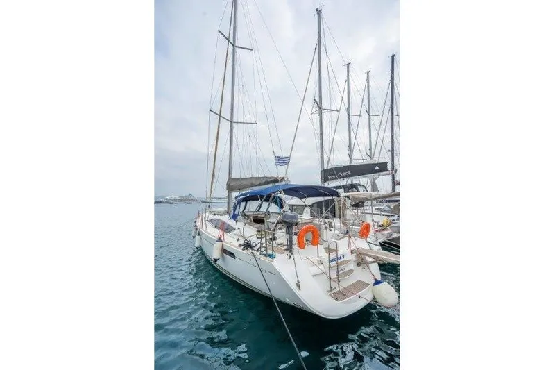  Yacht Photos Pics 2010 Jeanneau 53 sailboat docked in a marina, featuring a sleek design.