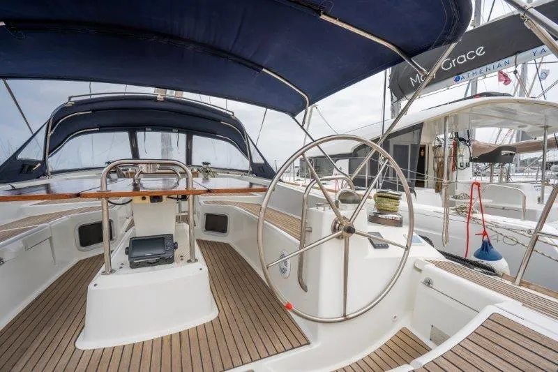  Yacht Photos Pics Cockpit of 2010 Jeanneau 53 sailboat with wooden deck and steering wheel.