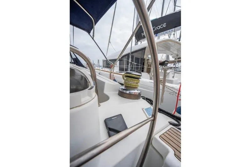  Yacht Photos Pics 2010 Jeanneau 53 yacht deck with winch and railing, docked at marina.