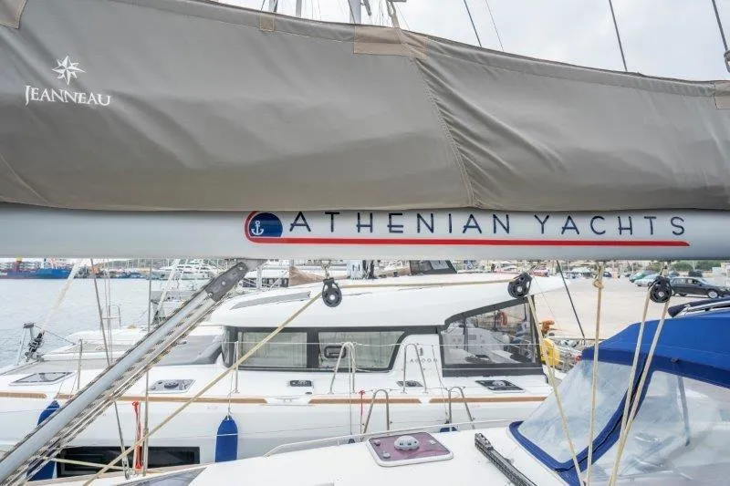  Yacht Photos Pics Jeanneau 53 sailboat from 2010, featuring Athenian Yachts branding at a marina.