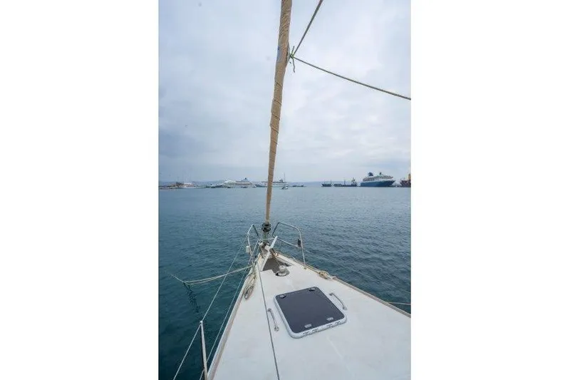 Yacht Photos Pics Bow view of 2010 Jeanneau 53 sailboat in a calm harbor setting.