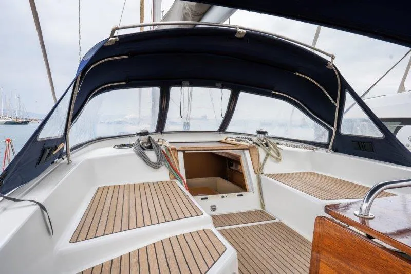  Yacht Photos Pics Cockpit of 2010 Jeanneau 53 sailboat with teak flooring and navy canopy.