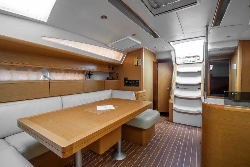  Yacht Photos Pics Interior of a 2010 Jeanneau 53 yacht with modern wood finish and seating area.