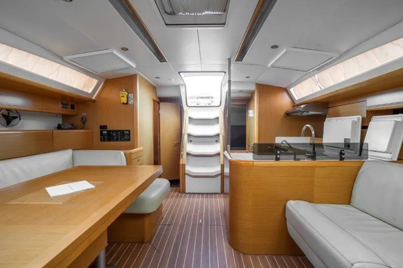  Yacht Photos Pics Interior of 2010 Jeanneau 53 yacht with modern wood finish and seating area.