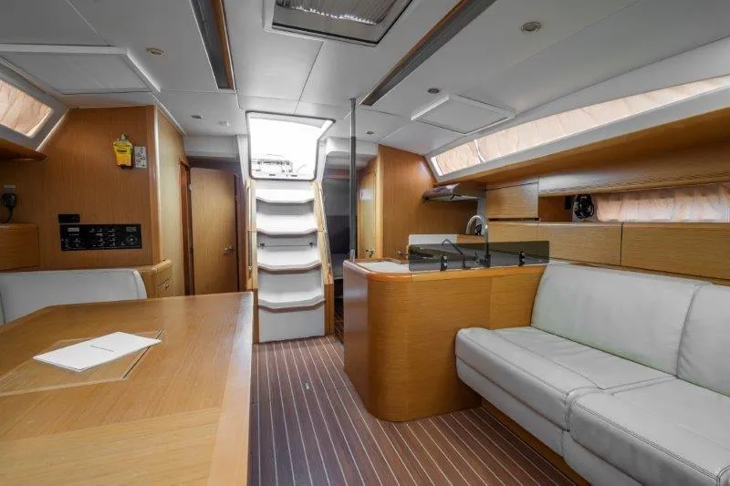  Yacht Photos Pics Interior of 2010 Jeanneau 53 yacht with modern wood finish and comfortable seating.