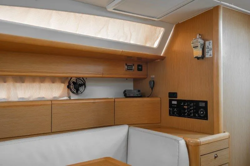  Yacht Photos Pics Interior of 2010 Jeanneau 53 yacht with wooden cabinetry and control panel.