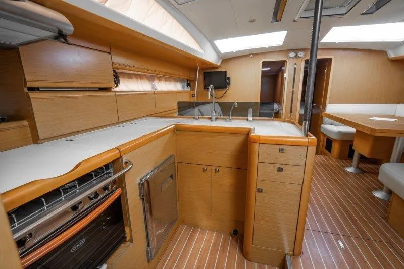  Yacht Photos Pics Interior of 2010 Jeanneau 53 yacht with modern kitchen and dining area.