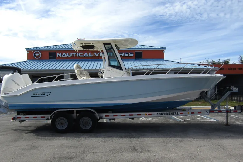  Yacht Photos Pics 2023 Boston Whaler 280 Dauntless boat on trailer at Nautical Ventures dealership.