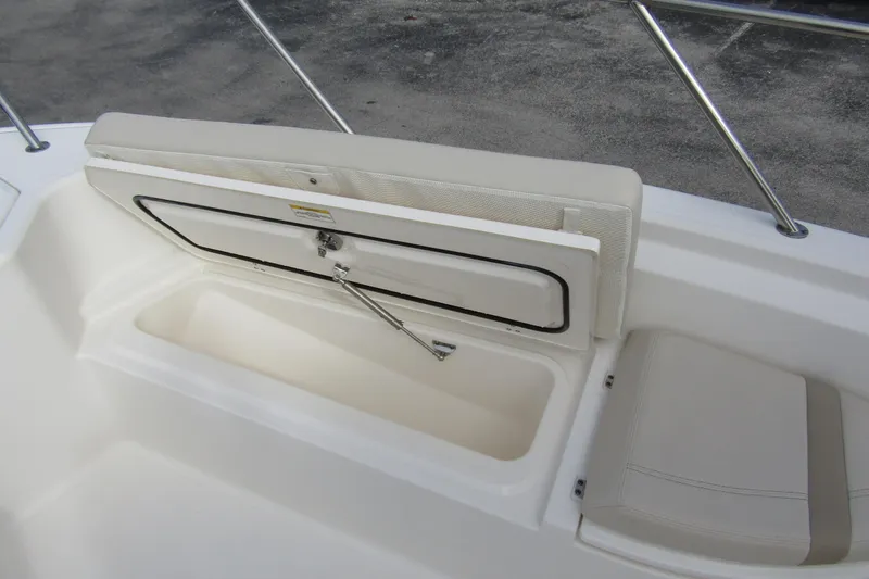  Yacht Photos Pics 2023 Boston Whaler 280 Dauntless boat storage compartment with cushioned seating.
