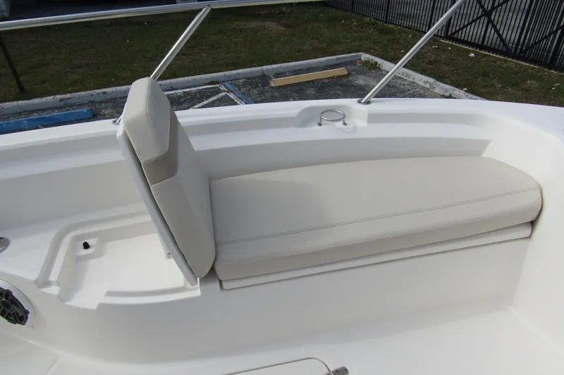  Yacht Photos Pics 2023 Boston Whaler 280 Dauntless boat seating area with cushioned bench and backrest.