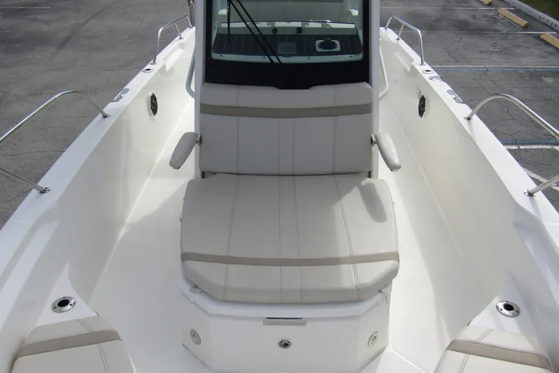 Yacht Photos Pics 2023 Boston Whaler 280 Dauntless boat interior with cushioned seating and armrests.