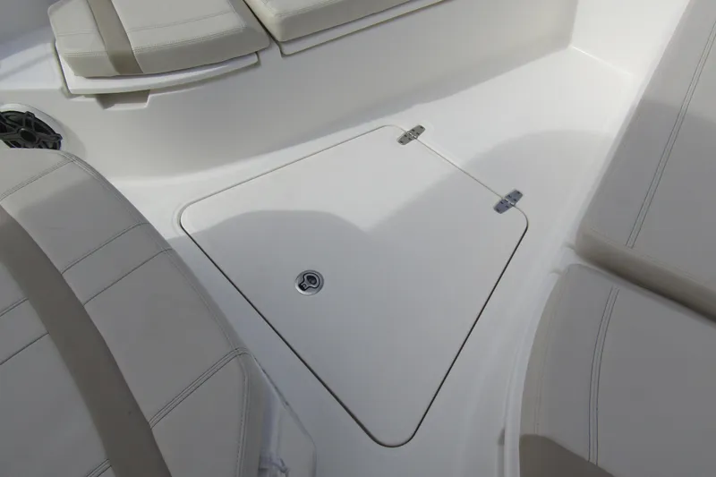  Yacht Photos Pics 2023 Boston Whaler 280 Dauntless boat interior with cushioned seating and storage hatch.