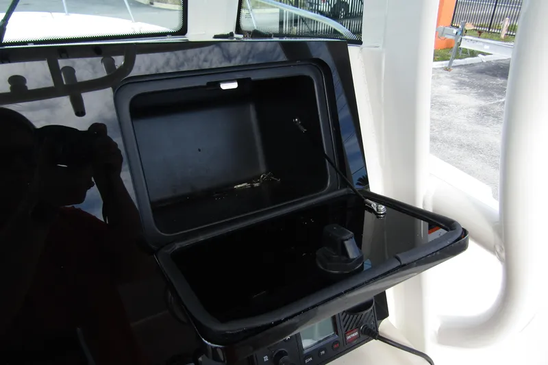  Yacht Photos Pics 2023 Boston Whaler 280 Dauntless console storage compartment with open lid and visible wiring.