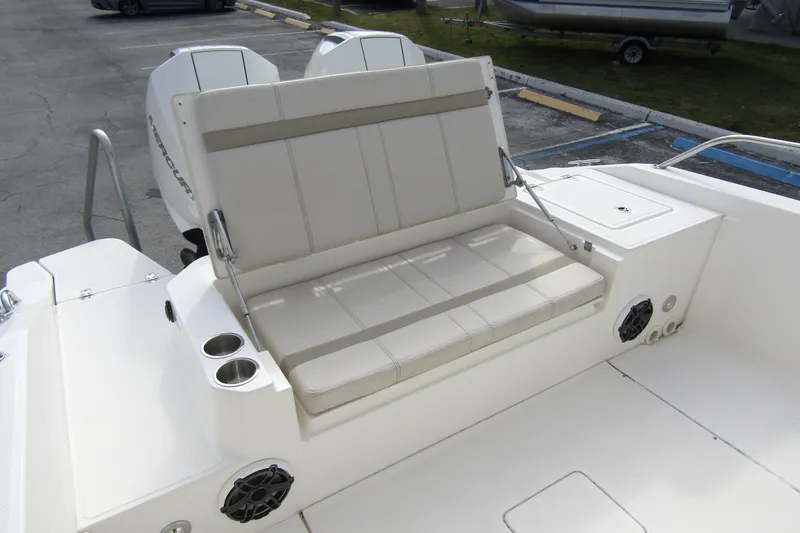  Yacht Photos Pics 2023 Boston Whaler 280 Dauntless boat seating area with cup holders and speakers.