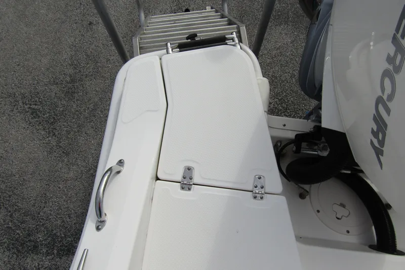  Yacht Photos Pics 2023 Boston Whaler 280 Dauntless boat deck with Mercury engine and swim ladder.