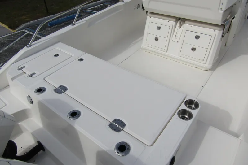  Yacht Photos Pics 2023 Boston Whaler 280 Dauntless interior with storage compartments and cup holders.