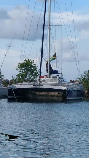 Kool Change Yacht Photos Pics Custom Spronk Day Charter Cat 50 pax 1984 catamaran docked in a serene marina.