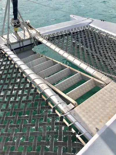 Kool Change Yacht Photos Pics Catamaran deck with netting and steps, Custom Spronk Day Charter Cat 50 pax, 1984.