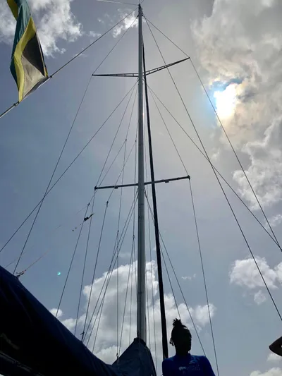 Kool Change Yacht Photos Pics 1984 Custom Spronk Day Charter Cat 50 pax sailboat mast against cloudy sky.