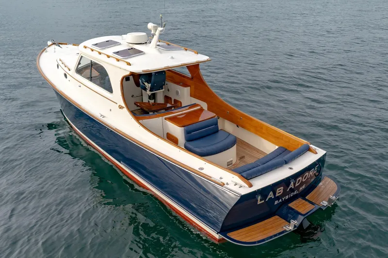 Lab Adore Yacht Photos Pics 2003 Hinckley Picnic Boat EP on water, elegant design, blue and white exterior.