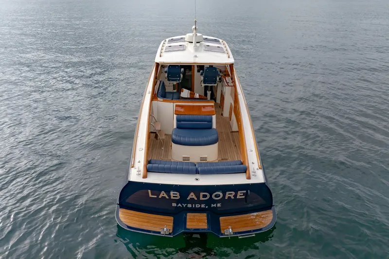 Lab Adore Yacht Photos Pics 2003 Hinckley Picnic Boat EP on water, rear view with seating and helm.