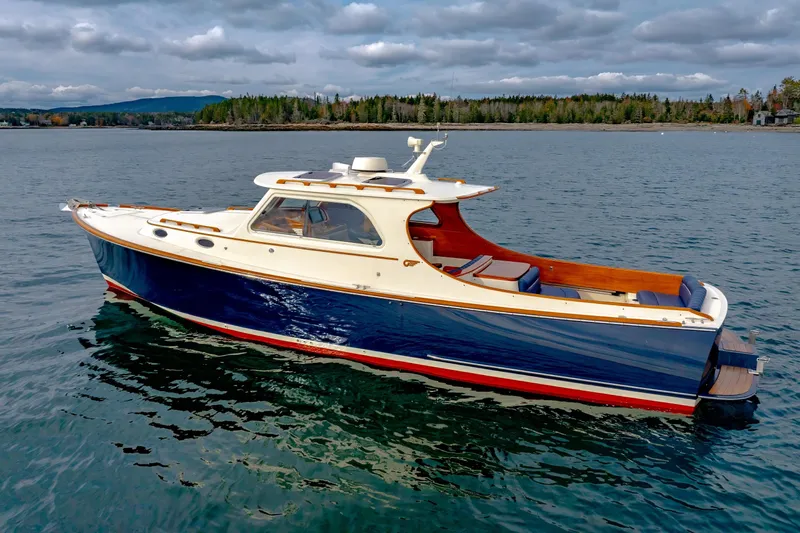 Lab Adore Yacht Photos Pics 2003 Hinckley Picnic Boat EP on calm water, scenic background, overcast sky.